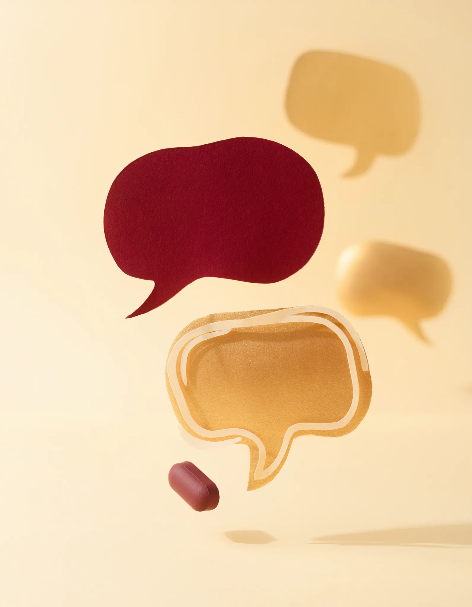 Floating speech bubbles in burgundy and gold on cream — personalised Business German coaching by Jump into German